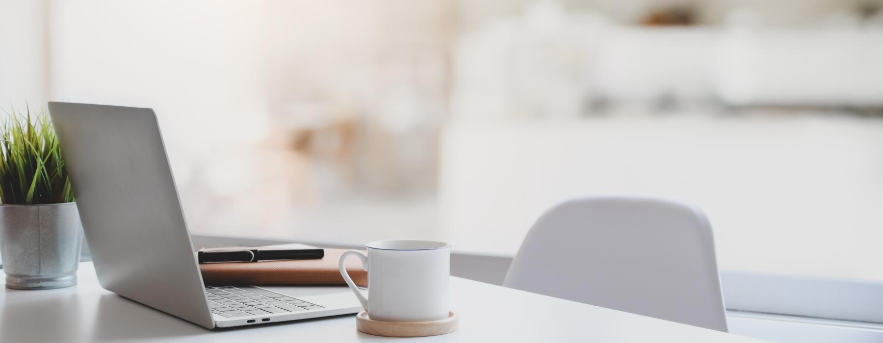 a laptop and a cup of coffee