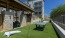 grass area with ping pong table and cornhole board