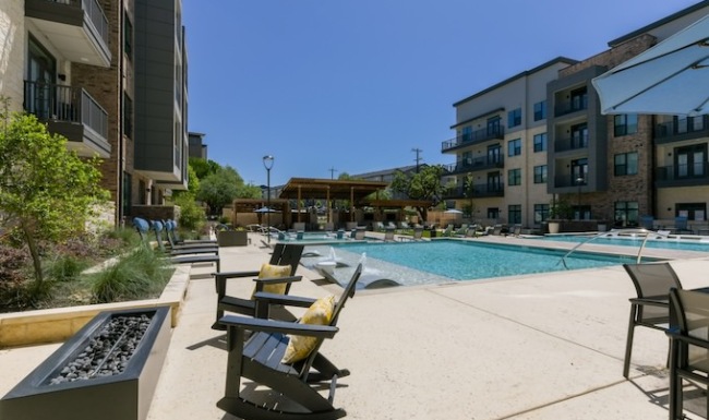 pool area with black lounge chairs