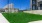 grassy field with building in background