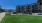 grass field with building in background