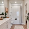 bathroom with tub/shower combination, framed in mirrors, and dual bathroom sinks