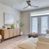 living room with sofa, coffee table, & view to the patio